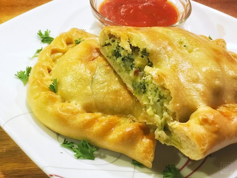 Cooking this Spinach Artichoke Calzone recipe from scratch in a tiny kitchen can be a labor of love but knowing how to make calzones is definitely worth it! | Tiny Kitchen Cuisine | https://tiny.kitchen